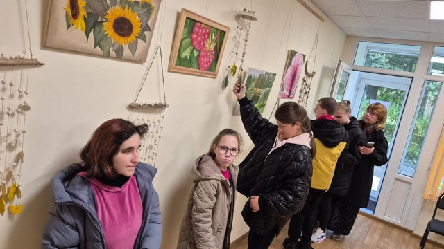Skolēni apskata un aptausta izstādes objektus.